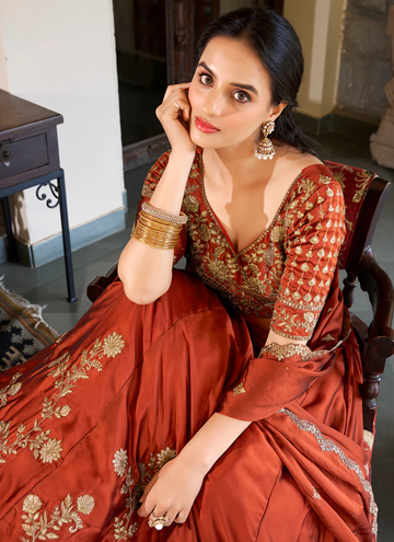 Draped in Rust, glowing in glow silk lehenga with zari, thread sequin work.